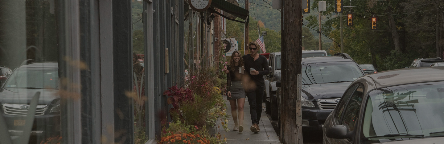 A couple walking down the street of a small downtown district