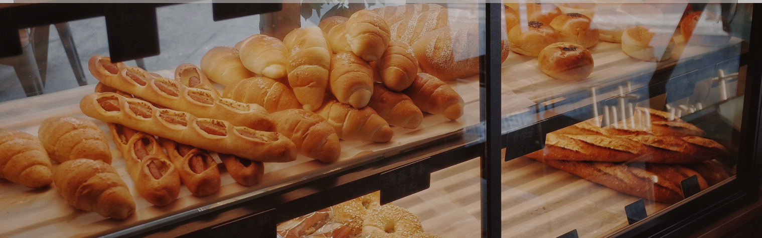 Image of bread and other baked goods behind glass