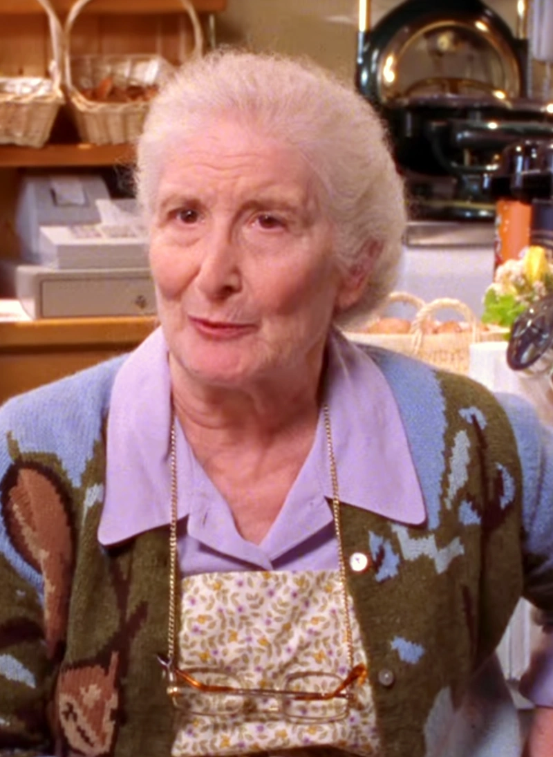 older lady looking into the camera with a sweater on